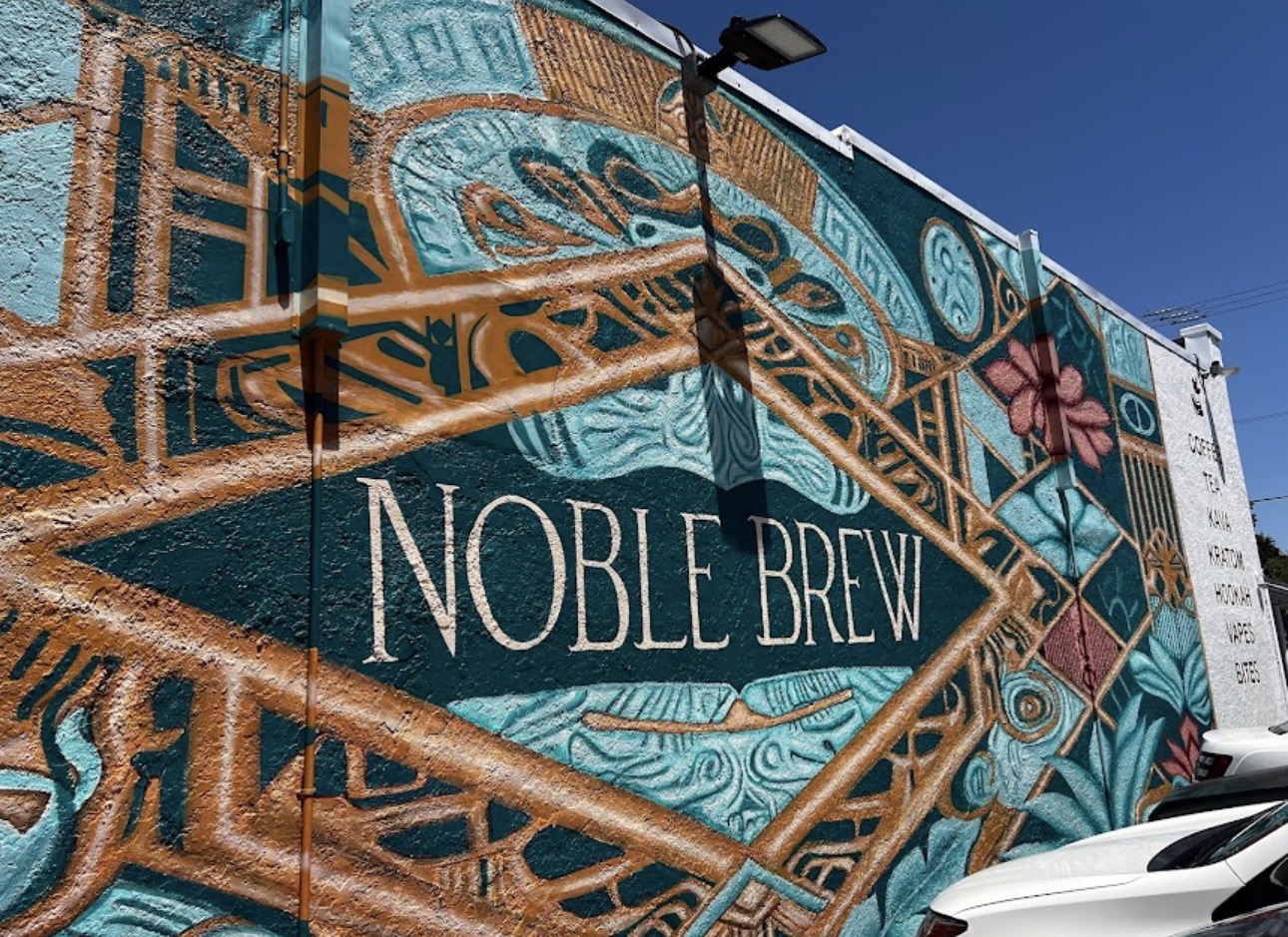 The Noble Brew exterior mural — teal and copper botanical artwork wrapping the building